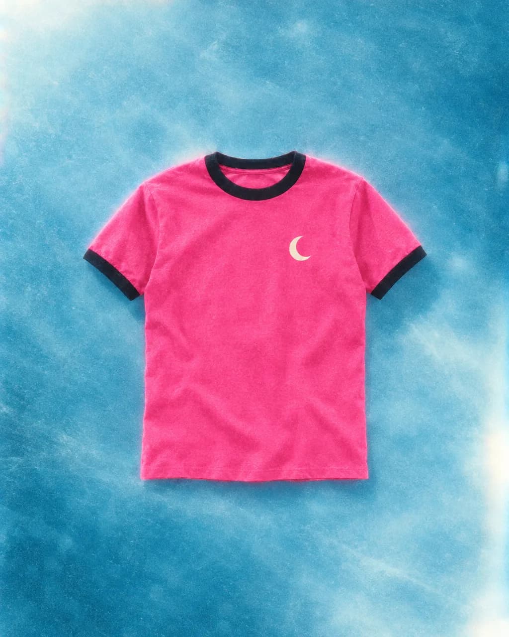 Hot-pink ringer t-shirt with black trim and a cream crescent-moon chest print