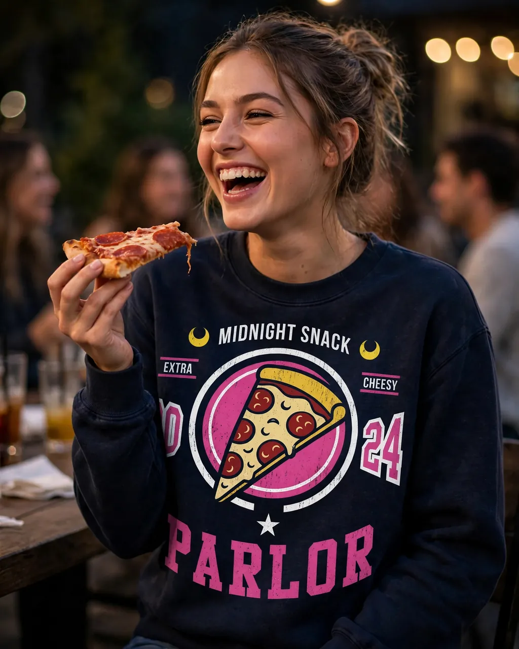 A creator laughing in a printed pizza-graphic sweatshirt